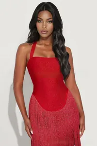 Detail of red halter dress with shimmering fabric and dense long fringe hemline