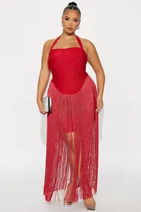 Detail showing the layered long fringe hem and sparkling fabric of the red halter dress