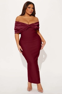 Detail of burgundy off-shoulder evening dress with a large decorative bow on the bust