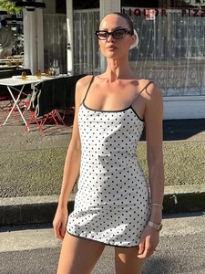 Chic slim fit white polka dot mini dress with black spaghetti straps and trim