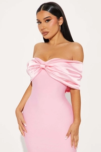 Detail of pink off-shoulder bodycon dress with large satin bow accent on the bodice