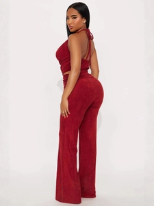 Women's burgundy halter neck crop top and high-waisted wide-leg trousers fashion set