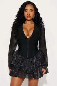 Detail of the deep V-neckline and corset waist on this elegant black ruffled mini dress