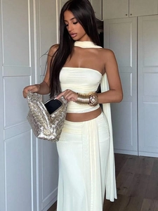 Close-up of cream three-piece set featuring a bandeau top, draped skirt and matching scarf