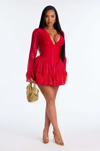 Detailed view of the deep V-neckline and ruffled tiered skirt of the red mini dress