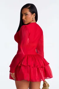 Detail of red long sleeve dress with ruffled layers and elegant waistline silhouette