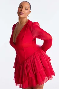 Detail of red V-neck dress featuring corset bodice and layered ruffle chiffon skirt
