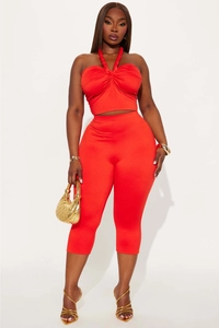 Detail of red halter neck crop top and matching high-waist tight cropped leggings set