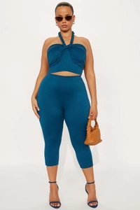 Detail view of navy halter crop top and matching high-waist capri leggings set