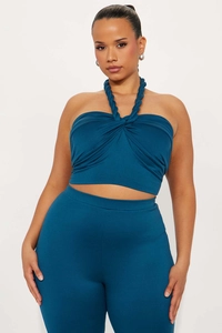 Detailed view of dark blue halter neck crop top with twisted strap design and matching pants