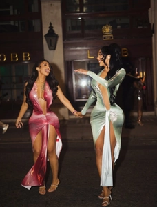 Detail of high-slit metallic evening dresses with V-neckline and cutout design