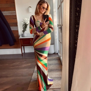 Detail of colorful radial stripes pattern on a slim-fit long-sleeved maxi dress