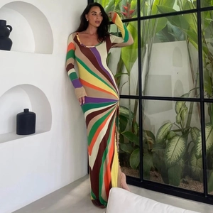 Detail view of the colorful rainbow striped knit fabric and side button closure on the dress