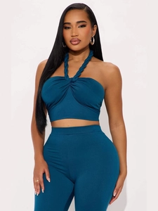 Women stylish teal halter crop top and high-waisted tight pants two-piece set