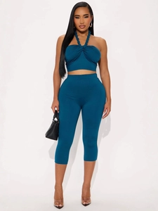 Peacock blue two-piece set featuring halter neck crop top and high-waist capri leggings