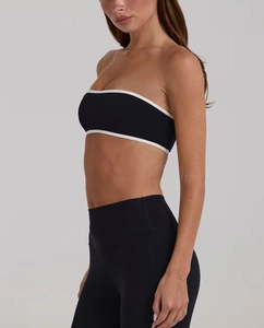 Detail view of black strapless sports bandeau with white contrast piping for women