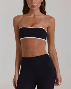 Detail of high-elastic black yoga set with white contrast trim and high waist leggings