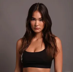 Close-up detail of white wolf head print on black high-impact sports bra for women
