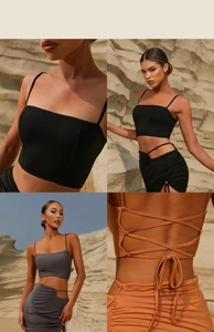 Detail of two-piece yoga set with lace-up back crop top and ruched skirt with metal ring