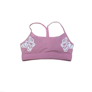 Detail of dusty pink sports bra with racerback straps and white wolf head graphic print