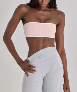 Close-up of pink bandeau bra with white trim and high-waist grey leggings set