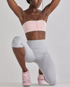 Detail of high-stretch seamless yoga set with pink tube top and light grey leggings