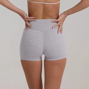 Dettaglio dei pantaloncini sportivi grigio chiaro con vita alta e tessuto strutturato