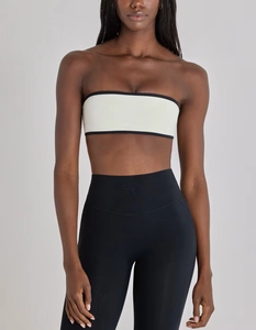 Detail view of the high-elastic white bandeau top with black contrast piping for fitness