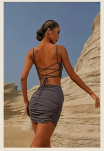 Close-up of ruched detail and criss-cross back straps on a charcoal yoga outfit