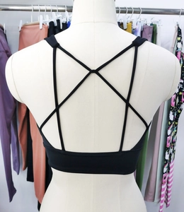 Detail view of black high-stretch sports bra with elegant cross-back straps and elastic band