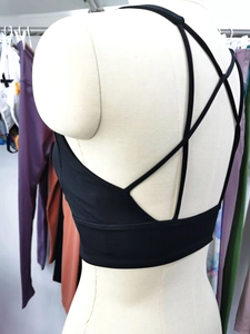 Close-up of black sports bra with cross back strap design on a mannequin