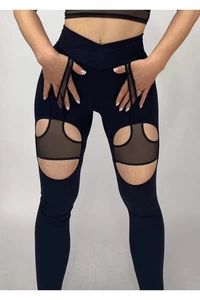 Dettaglio dei leggings yoga a vita alta con taglio a V e inserti in rete nera