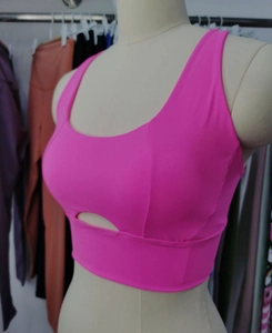 Detail view of rose red high-impact sports bra with hollow-out design on mannequin