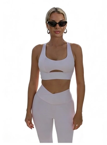 Front view of pink sports bra with hollow out detail and high waist yoga leggings