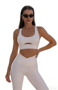Detailed view of the white high-waisted yoga leggings with stylish V-cross waist design