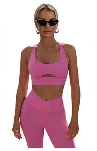 Detail of pink shockproof yoga sports bra with cutout design and high-waisted leggings set