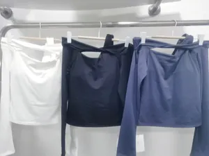 Three long-sleeve sports tops in white, black, and navy with off-shoulder cutouts
