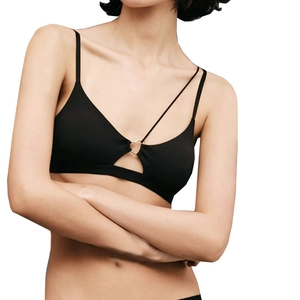 Deep V-neck yoga top in black ribbed fabric with a gold heart ring and asymmetric straps