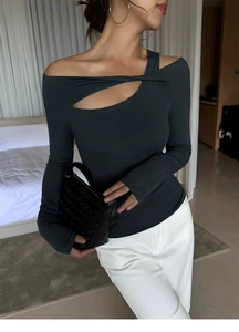 Detail view of women's off-shoulder yoga top featuring a cross cutout and slim fit design