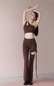 Detail of dark brown one-shoulder yoga jumpsuit with side hollow-out tie-up design