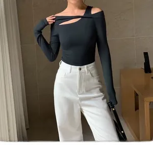 Detail of black slim fit yoga top with asymmetric off-shoulder and cutout neckline design