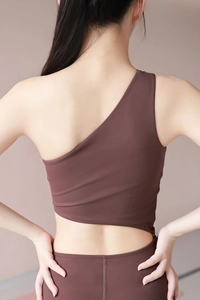Detail of dark brown one-shoulder yoga bodysuit featuring asymmetric back cutout design