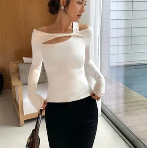 Detail of white slim-fit yoga top featuring asymmetric off-shoulder and cutout neckline