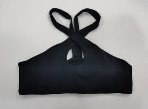 Détail du soutien-gorge de sport noir avec bretelles croisées et découpe frontale