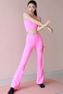 Close-up of bright pink one-shoulder top and flared yoga pants with hollow leg detail