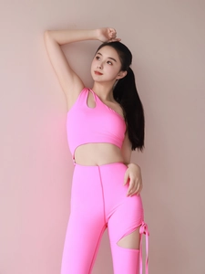 Detail of pink one-shoulder yoga set with side cutout and lace-up tight fitness leggings