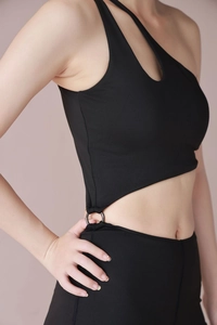Detail view of black one-shoulder yoga jumpsuit featuring a stylish metal waist ring