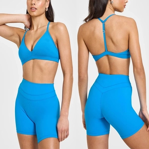 Detail of blue high-waist yoga shorts and V-neck sports bra with cross-back straps