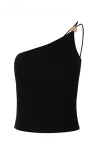 Detail view of black one-shoulder yoga sports bra with brown spherical decorative bead