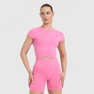 Pink high-elastic yoga top detail showing the breathable fabric and slim fit design